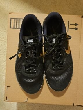 Nike Black Athletic Shoes with Gold Swoosh